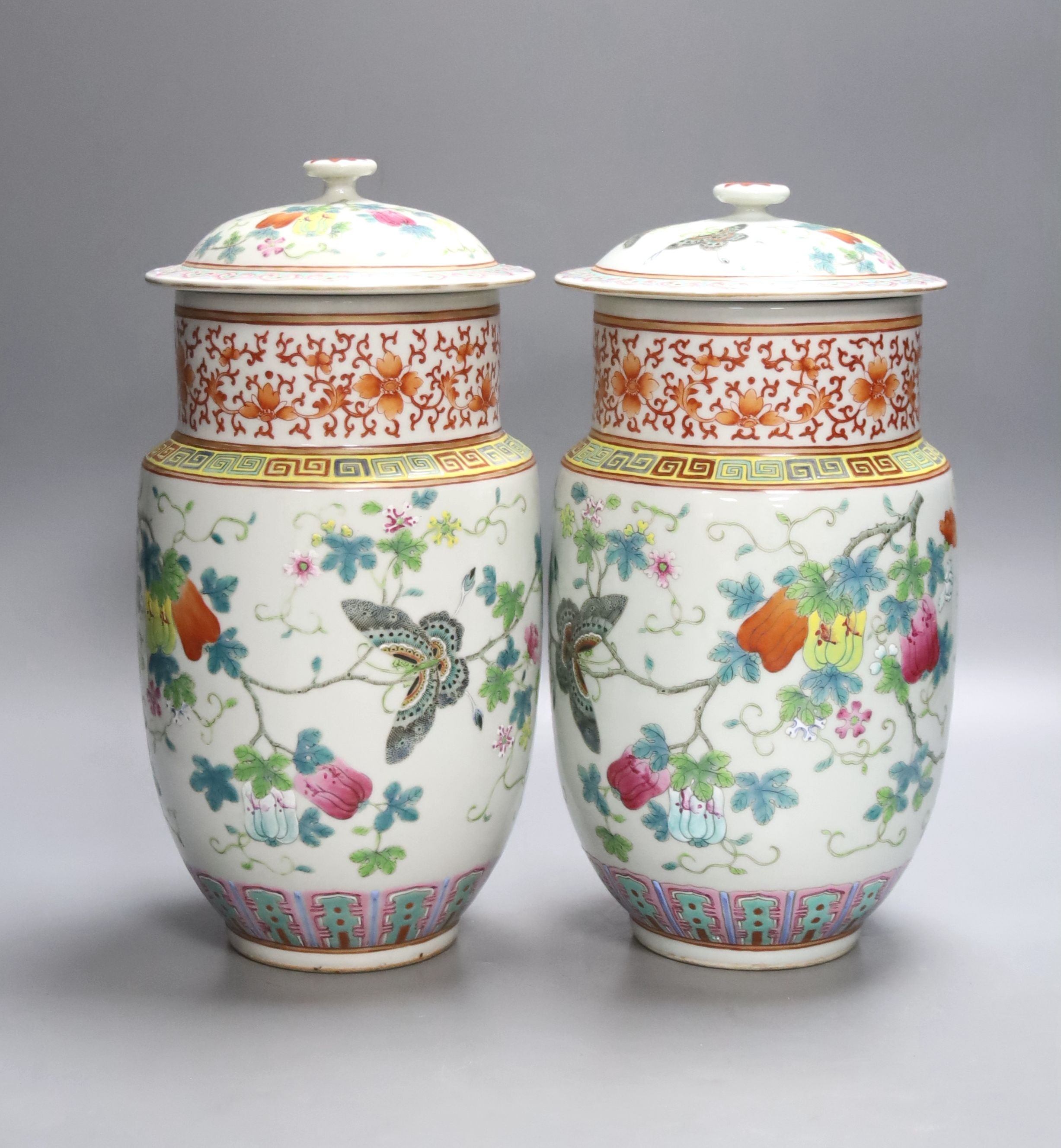 A pair of Chinese famille rose vase and covers, height 26cm